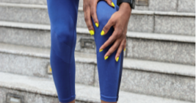 Runner holding the front of her knee, patellofemoral pain treatment in Racine, WI