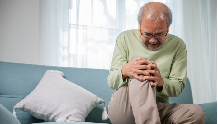 Chiropractor treating a patient's knee for osteoarthritis at Daniels Chiropractic in Racine, WI.