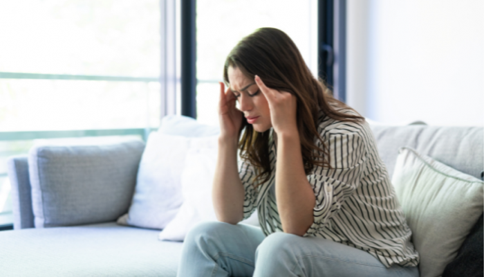 Woman pressing her temples with a tension headache, headache treatment in Racine, WI